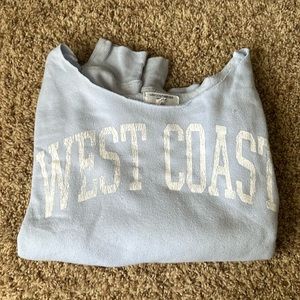 This is a greyson threads blue west coast off the shoulder sweater in light blue